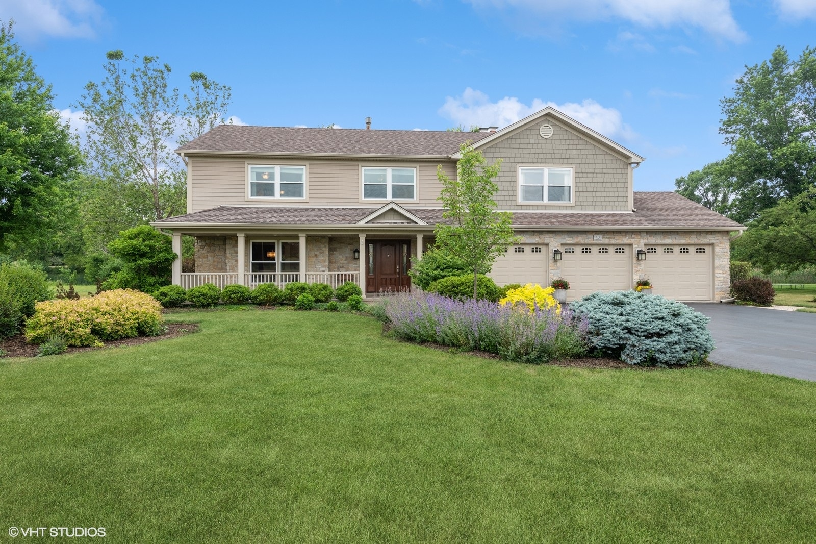 a front view of a house with a garden