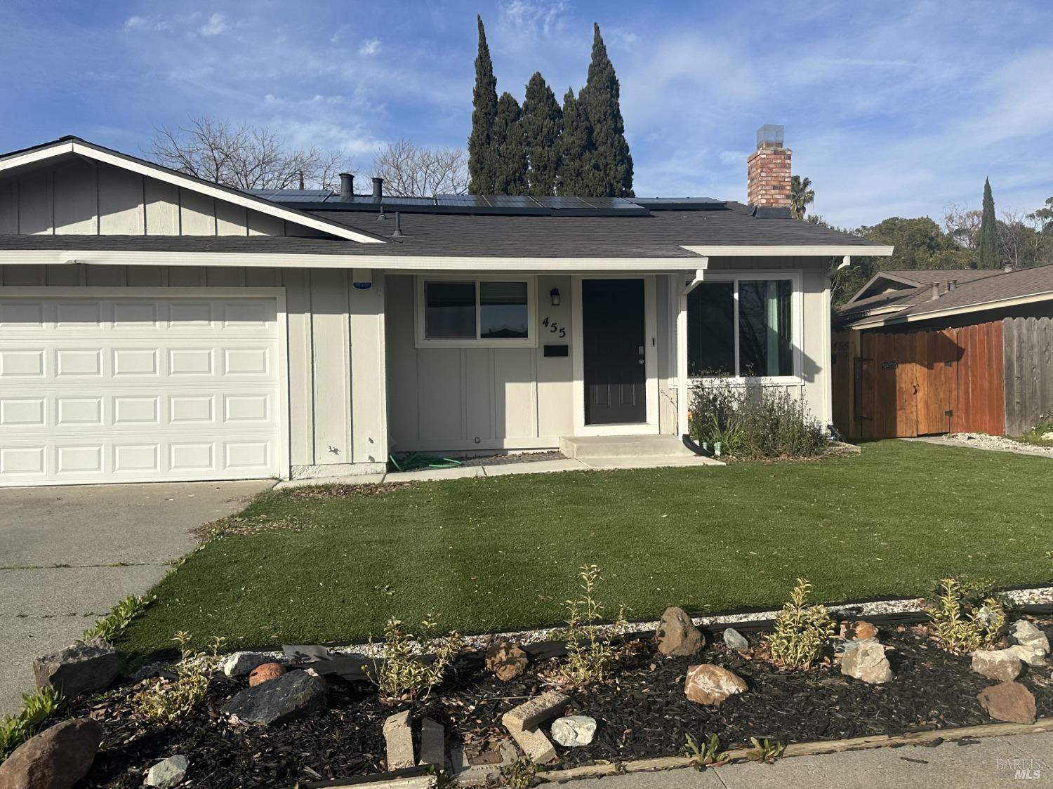 a front view of a house with a garden