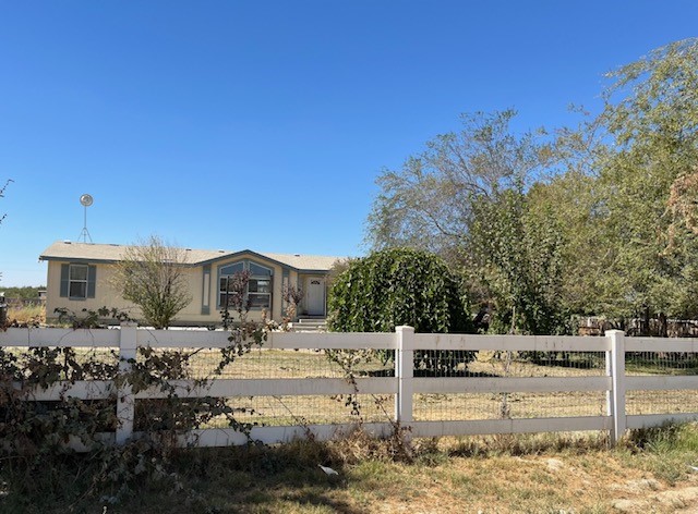 a view of a house with cars parked