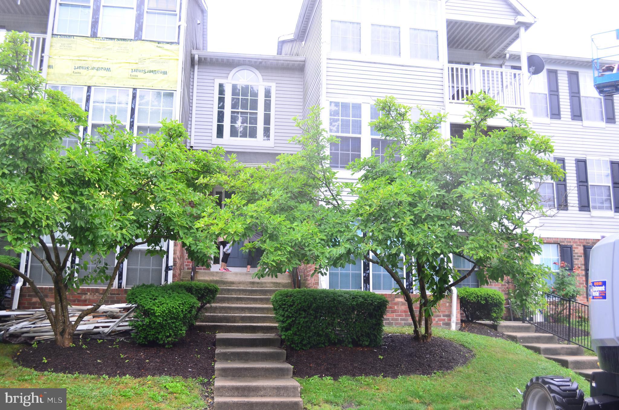 a front view of a multi story building with yard