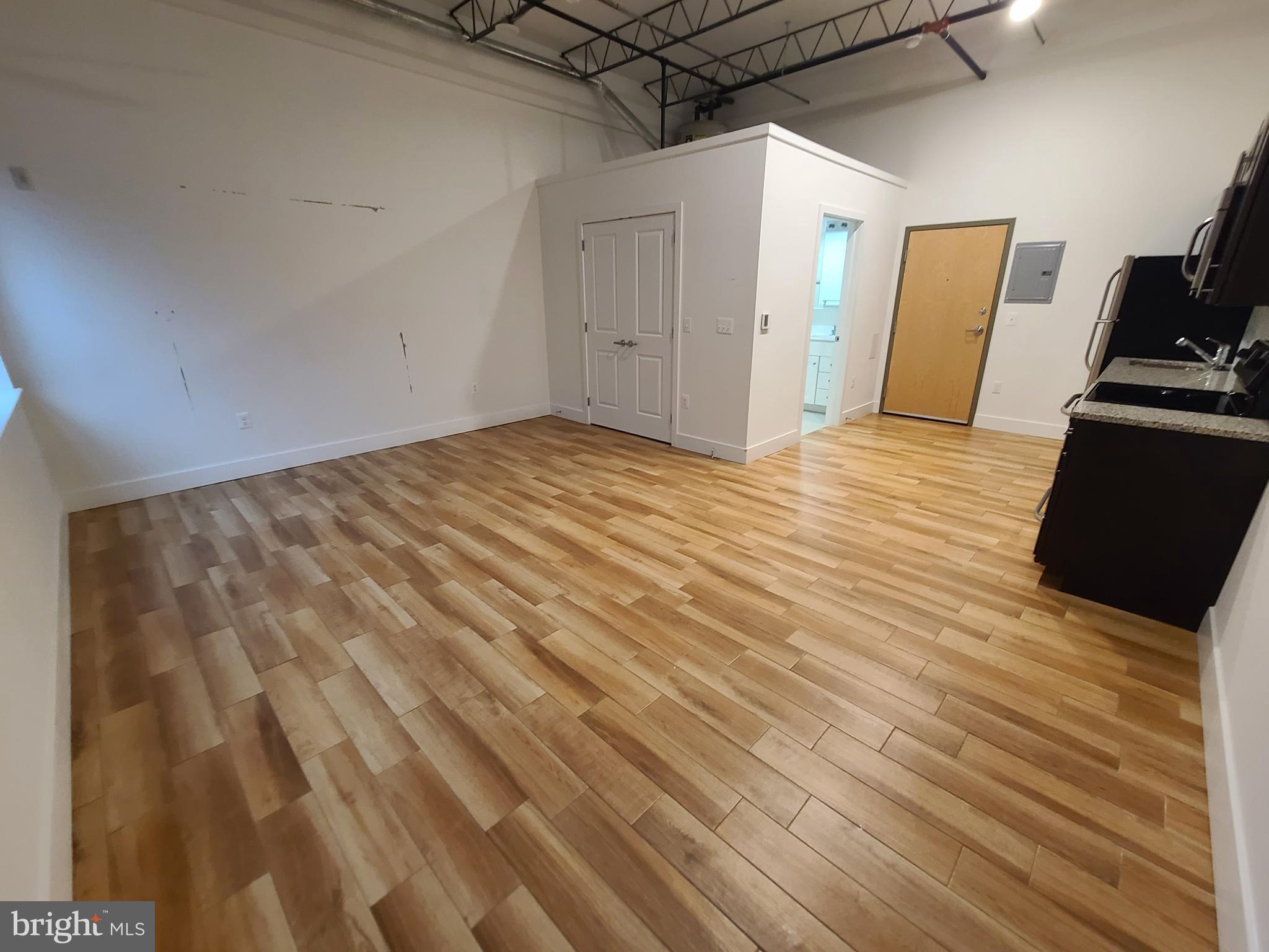 a view of a room with wooden floor