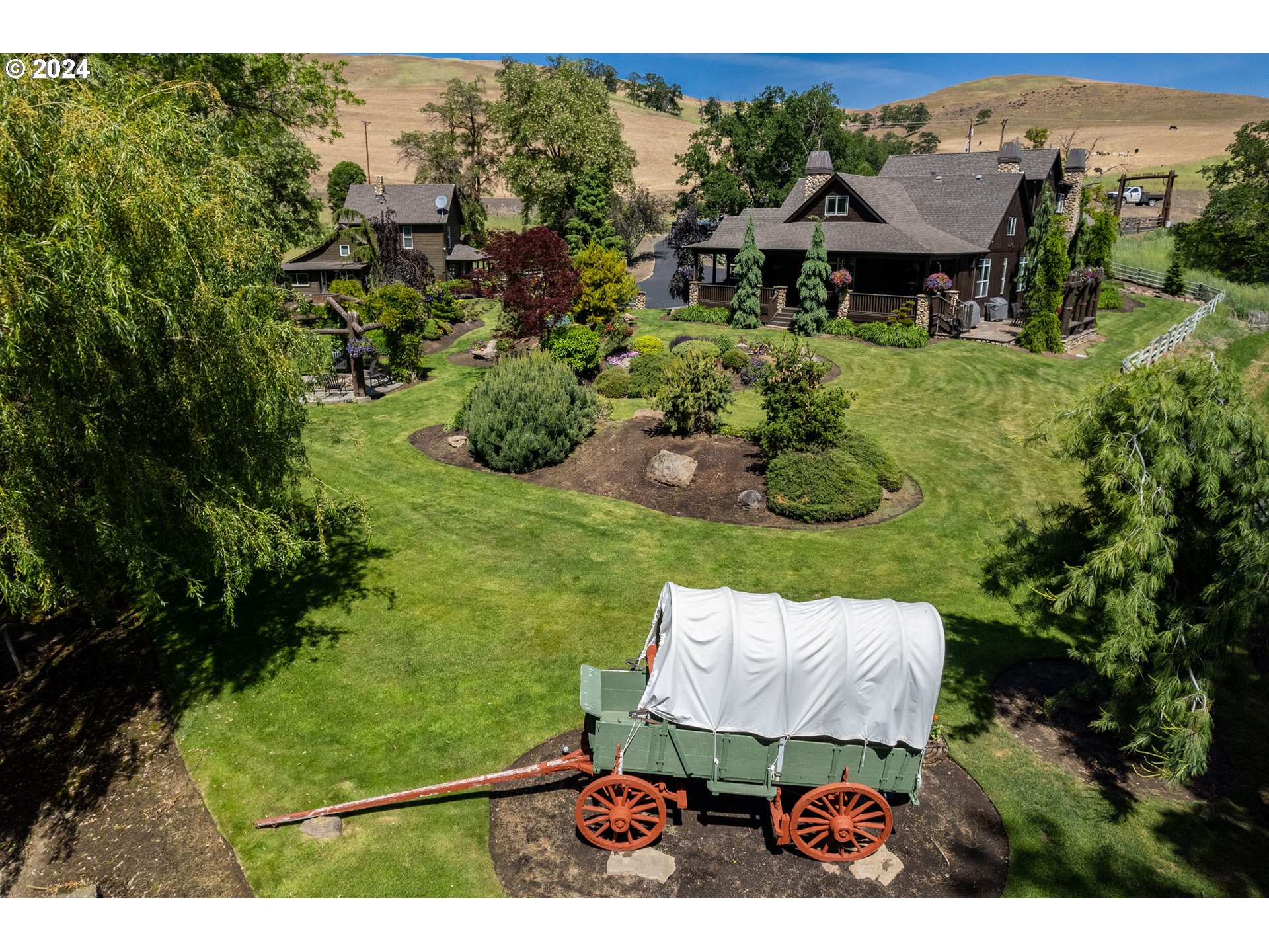 an aerial view of a house with pool yard and outdoor seating