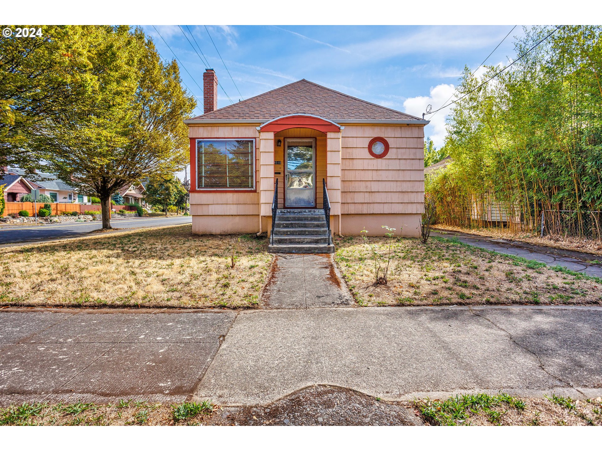 a front view of a house with garden