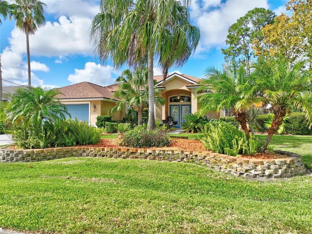 a front view of a house with a garden