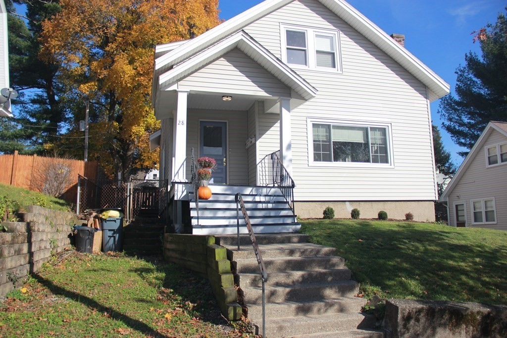 a front view of a house with garden