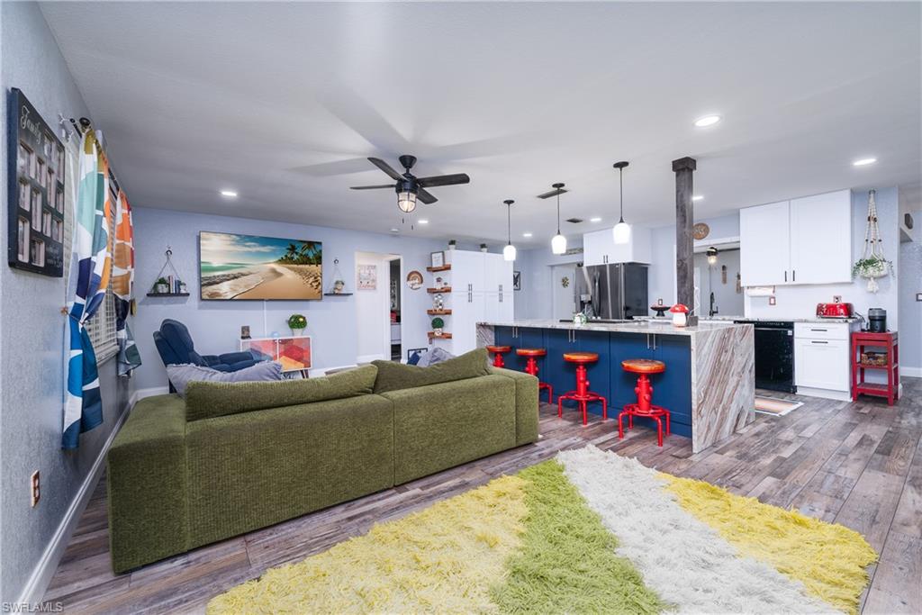 Living room featuring ceiling fan, hardwood / wood-style flooring, and sink