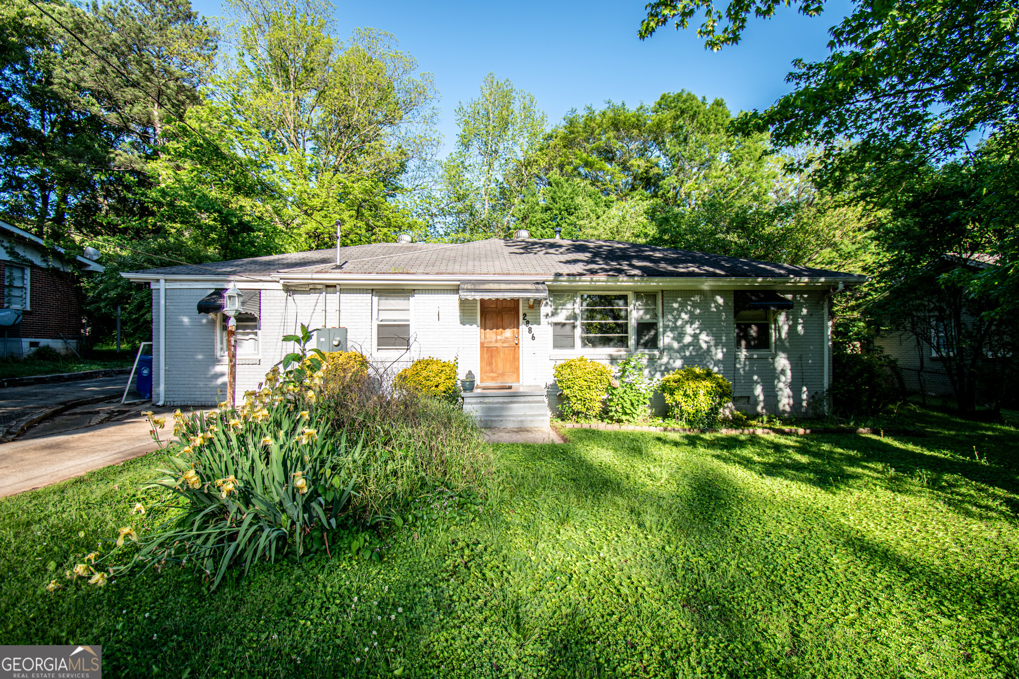 a front view of a house with a yard table and chairs