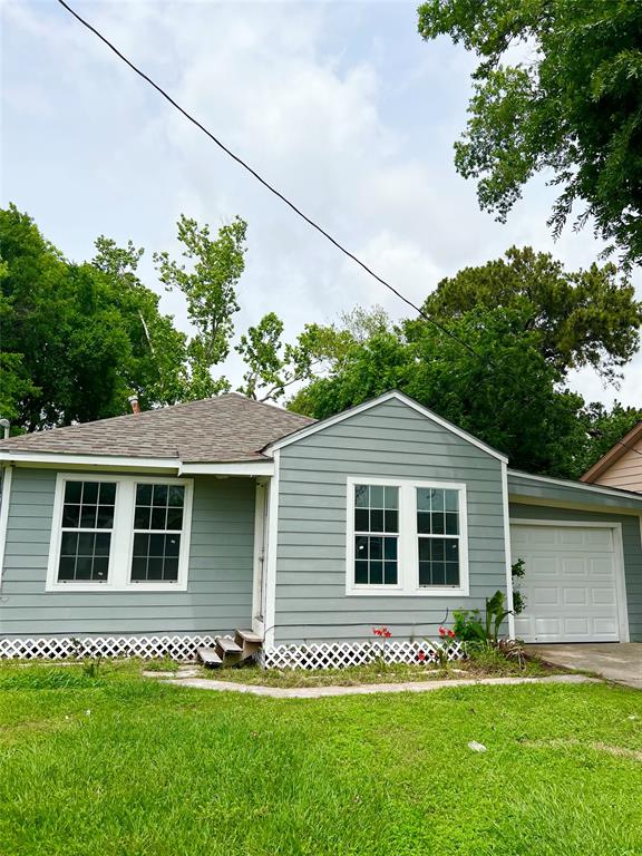 a front view of a house with a garden and plants