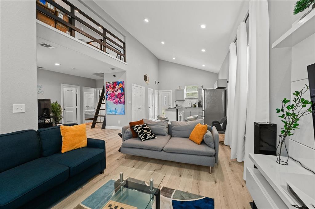 a living room with furniture and kitchen view