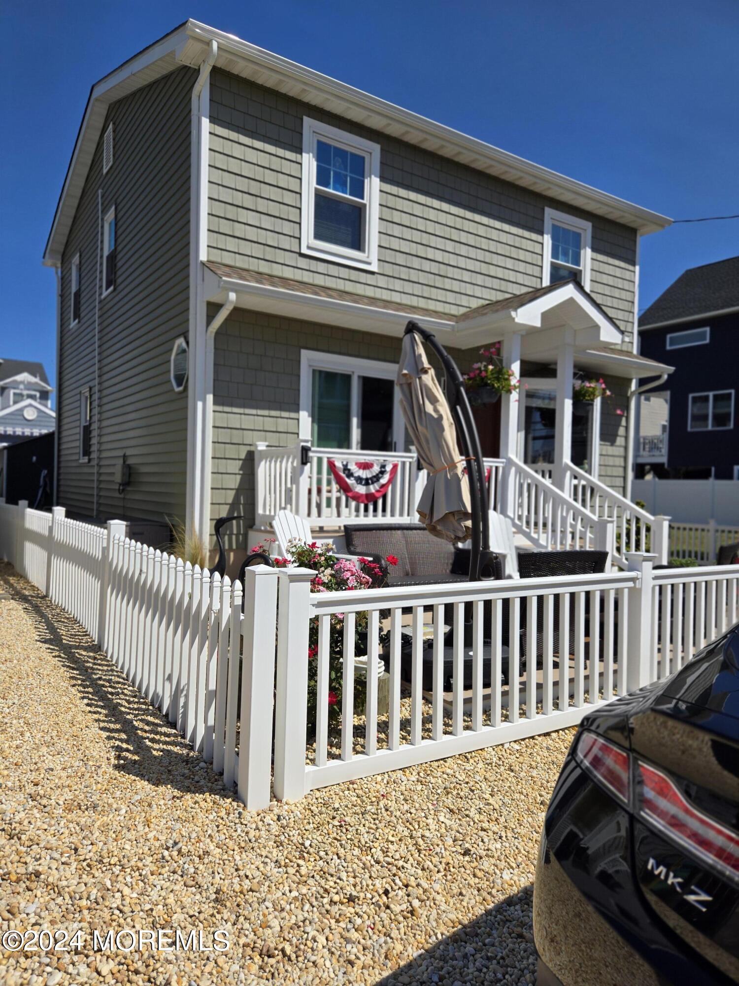 a view of a house with wooden deck