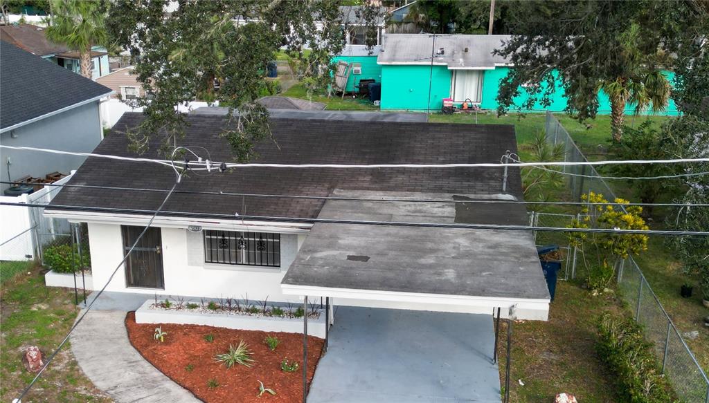 an aerial view of residential houses with outdoor space and parking