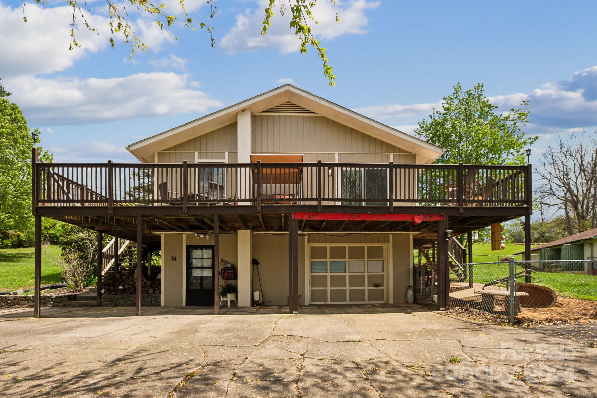 a view of a house with a patio and a yard