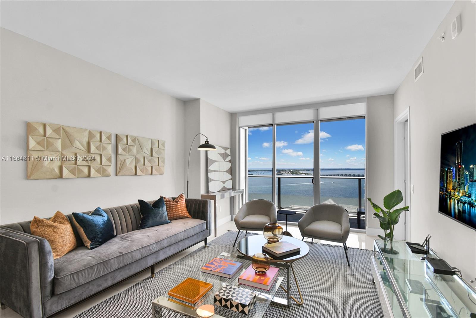 a living room with furniture and floor to ceiling window