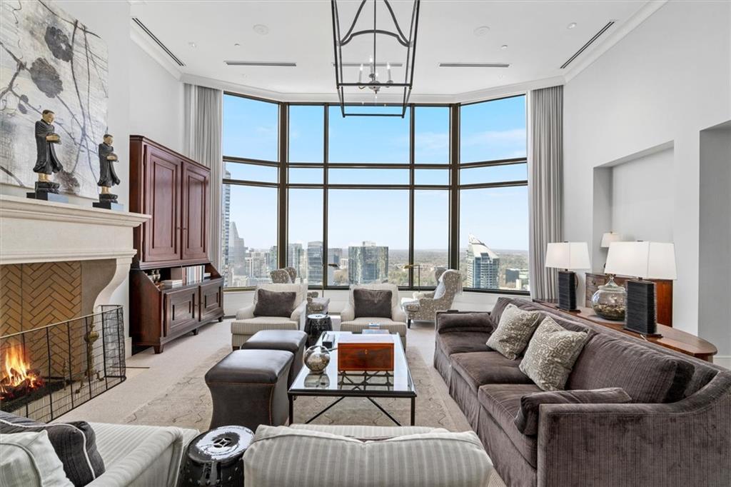 a living room with furniture large window and fireplace