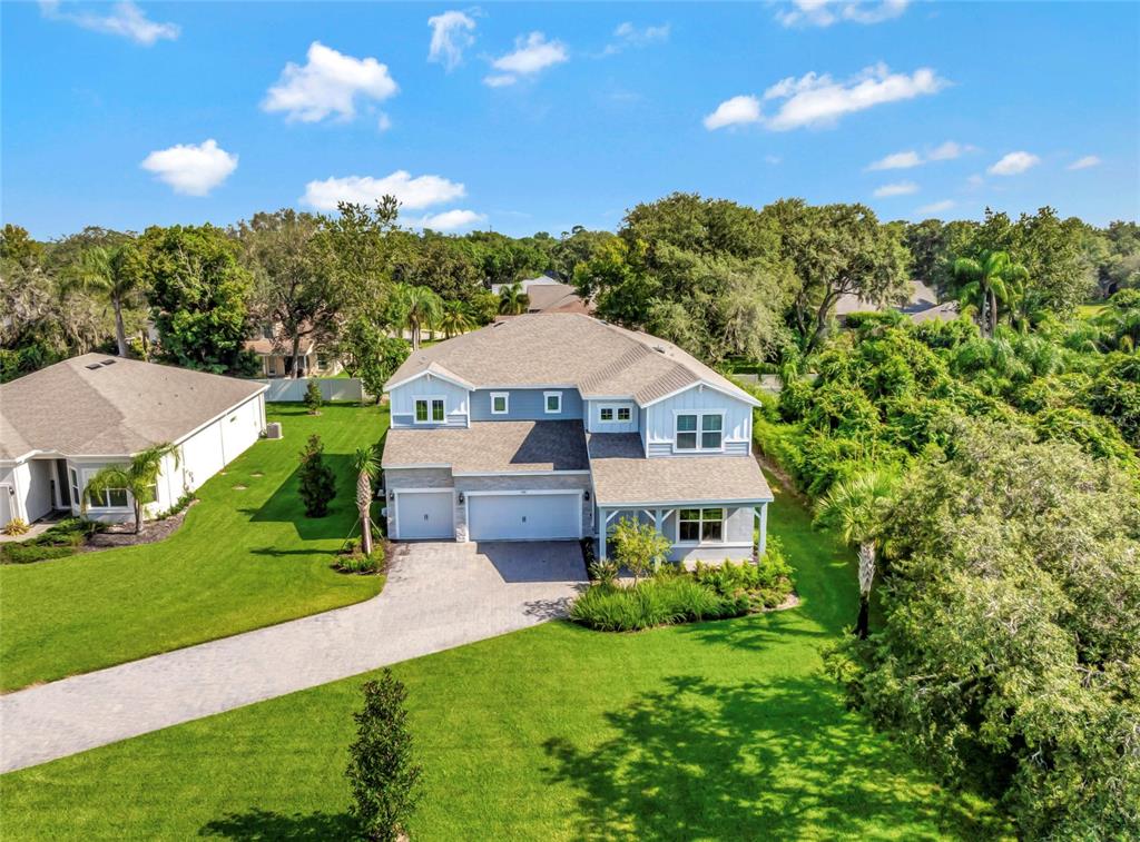 a aerial view of a house in middle of the green field