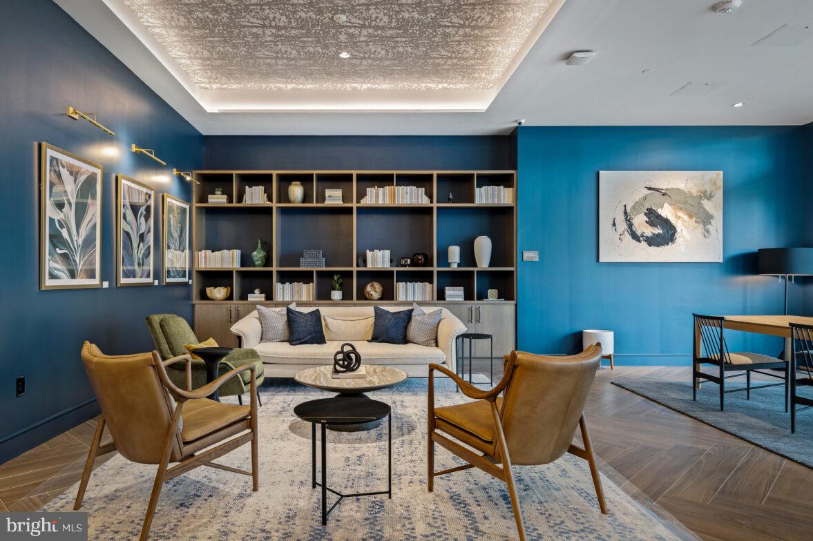 a living room with furniture and a book shelf