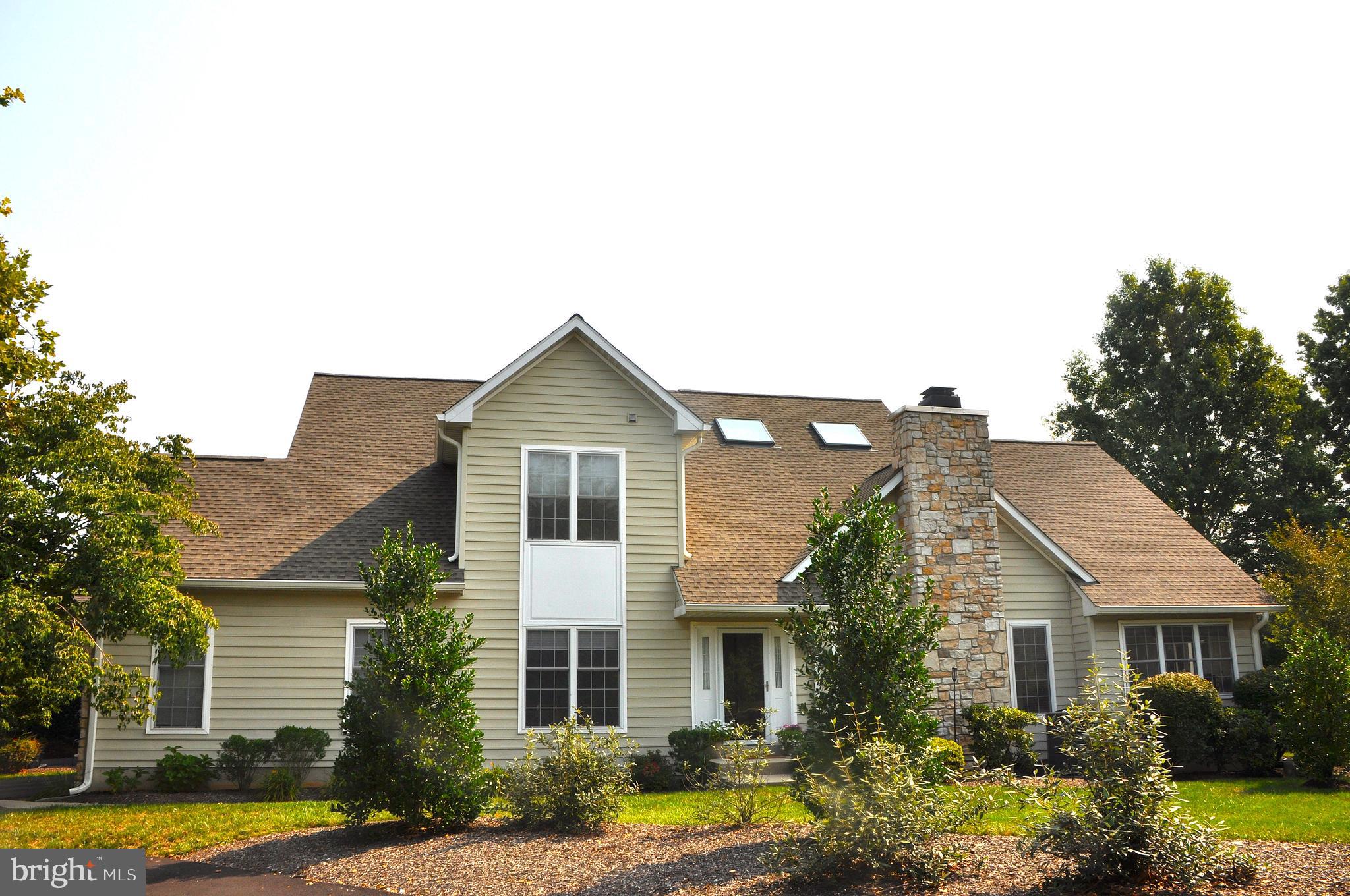 a view of a house with swimming pool and a yard