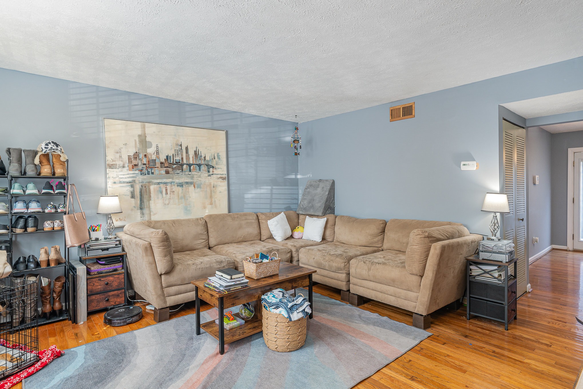 a living room with furniture and a book shelf