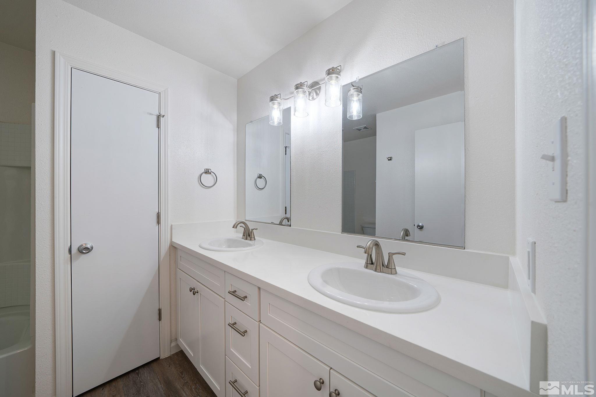 a bathroom with a sink double vanity and a mirror