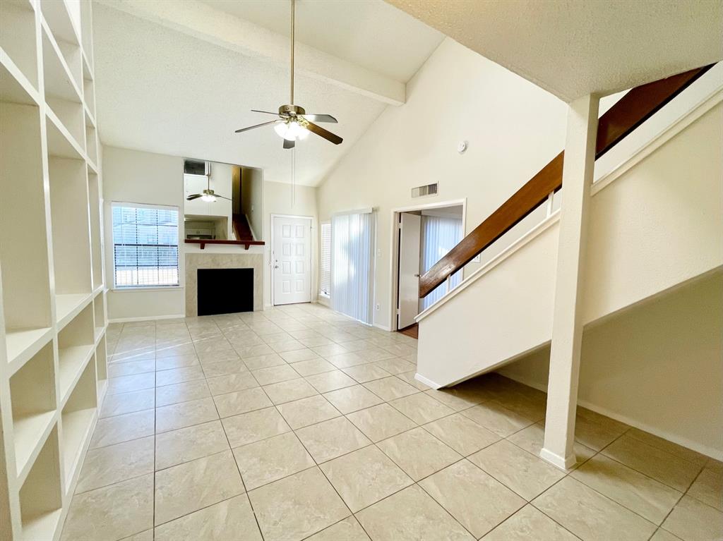 a view of kitchen with microwave and refrigerator