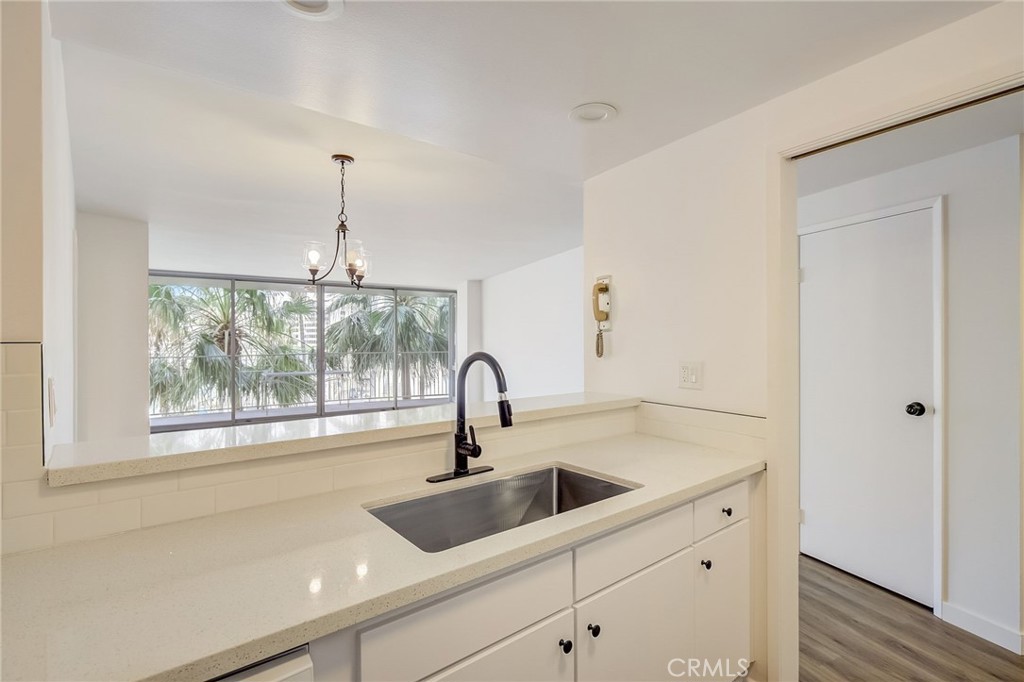 a kitchen with a sink and large window