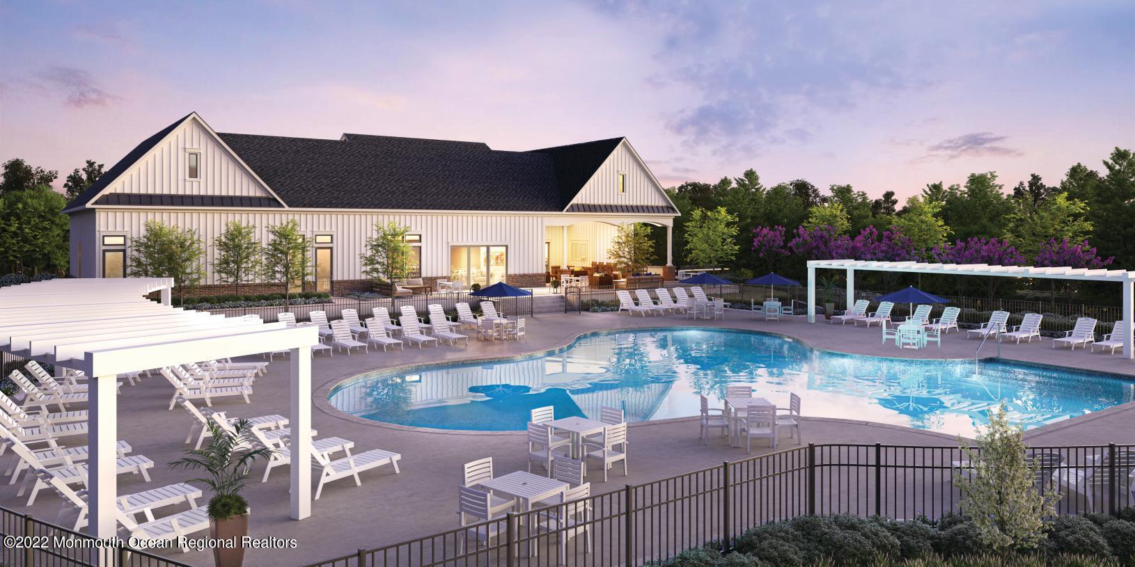 a swimming pool with outdoor seating and yard in the back