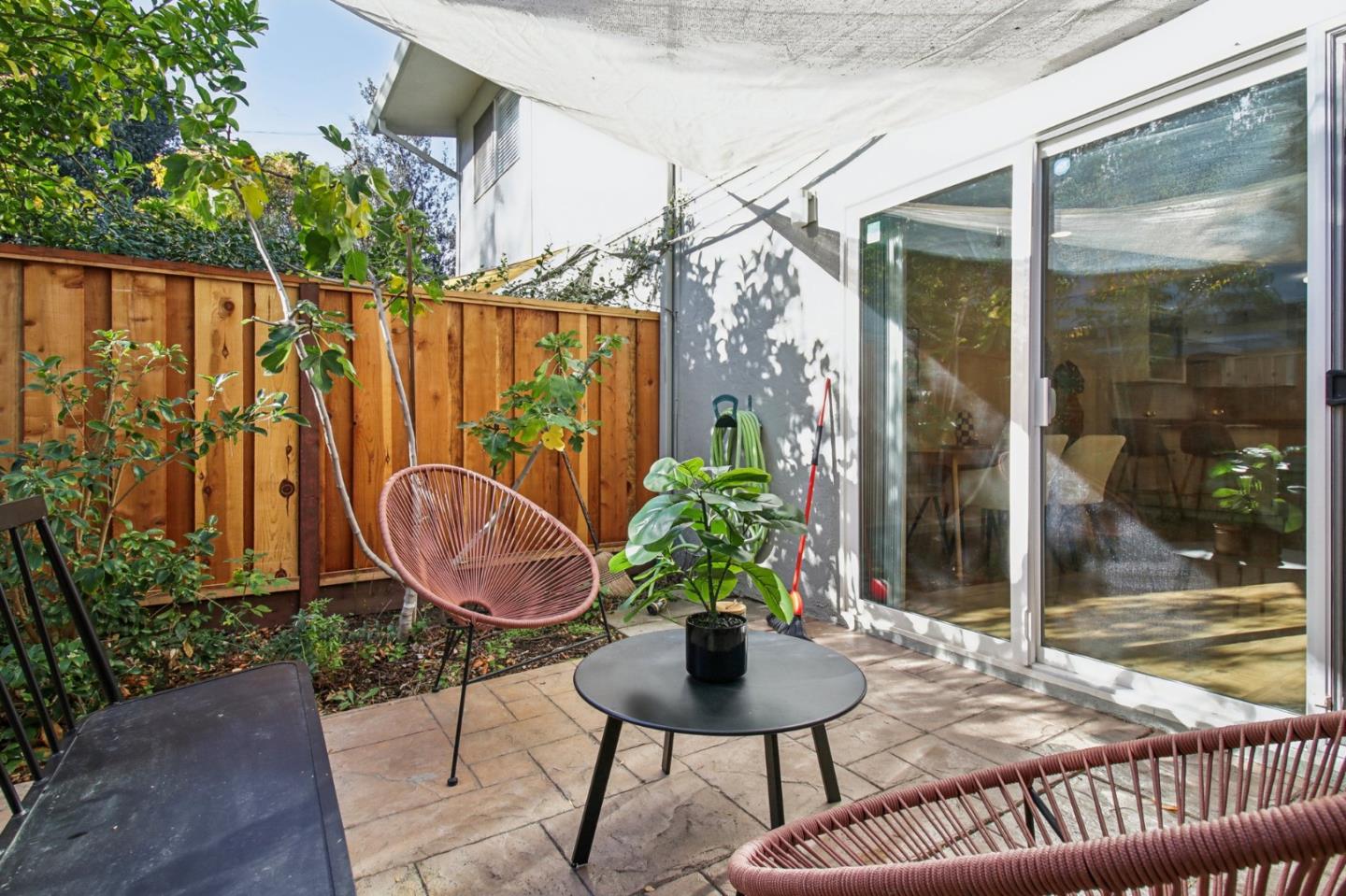 a view of a chairs and table in backyard of the house