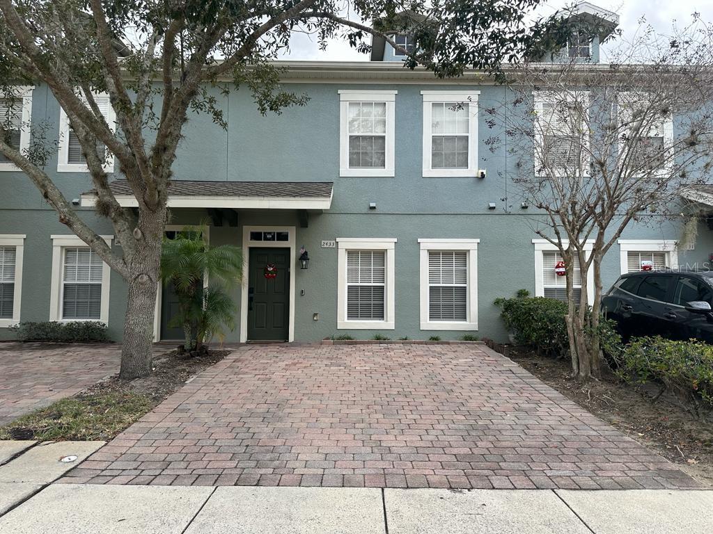 a front view of a house with a garden