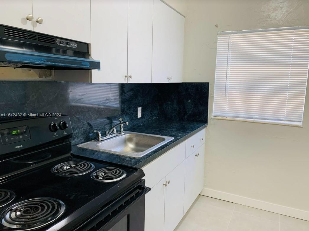 a kitchen with a stove and a microwave