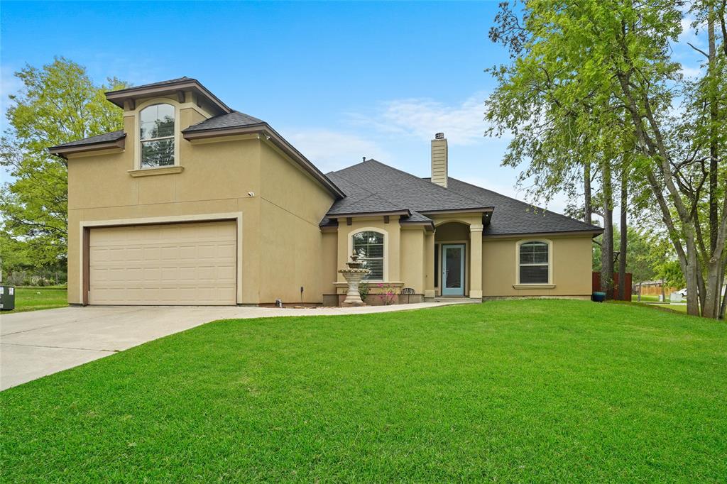 a front view of a house with a garden and yard