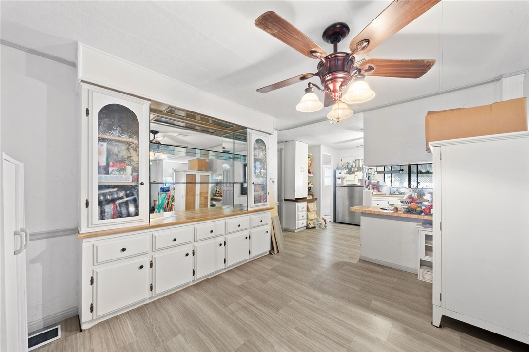 a kitchen with white cabinets and chandelier