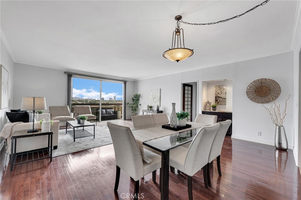 a view of a dining room with furniture wooden floor and chandelier