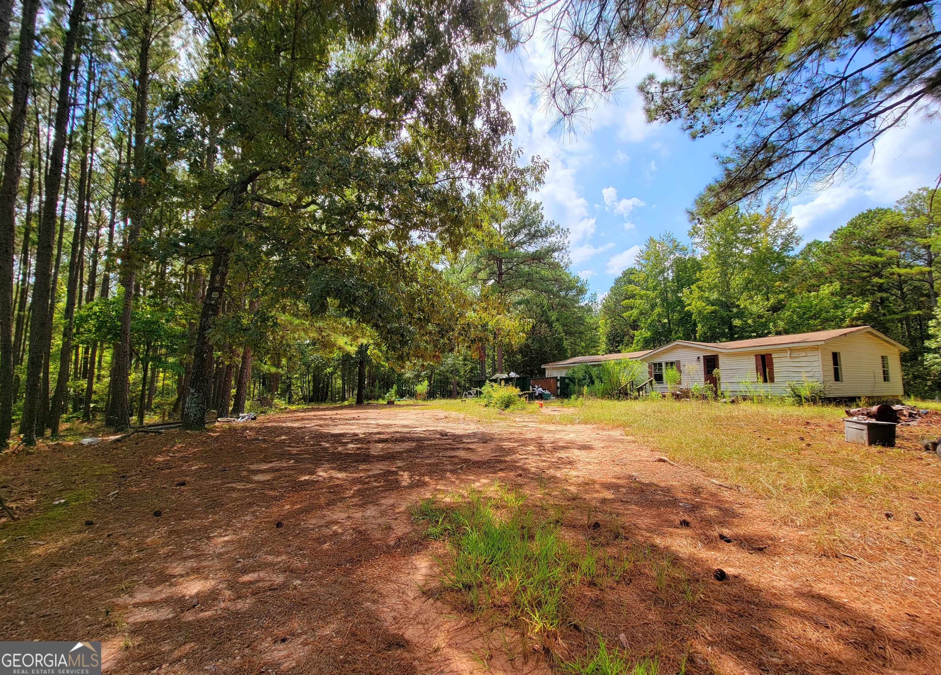 a backyard of a house with large trees