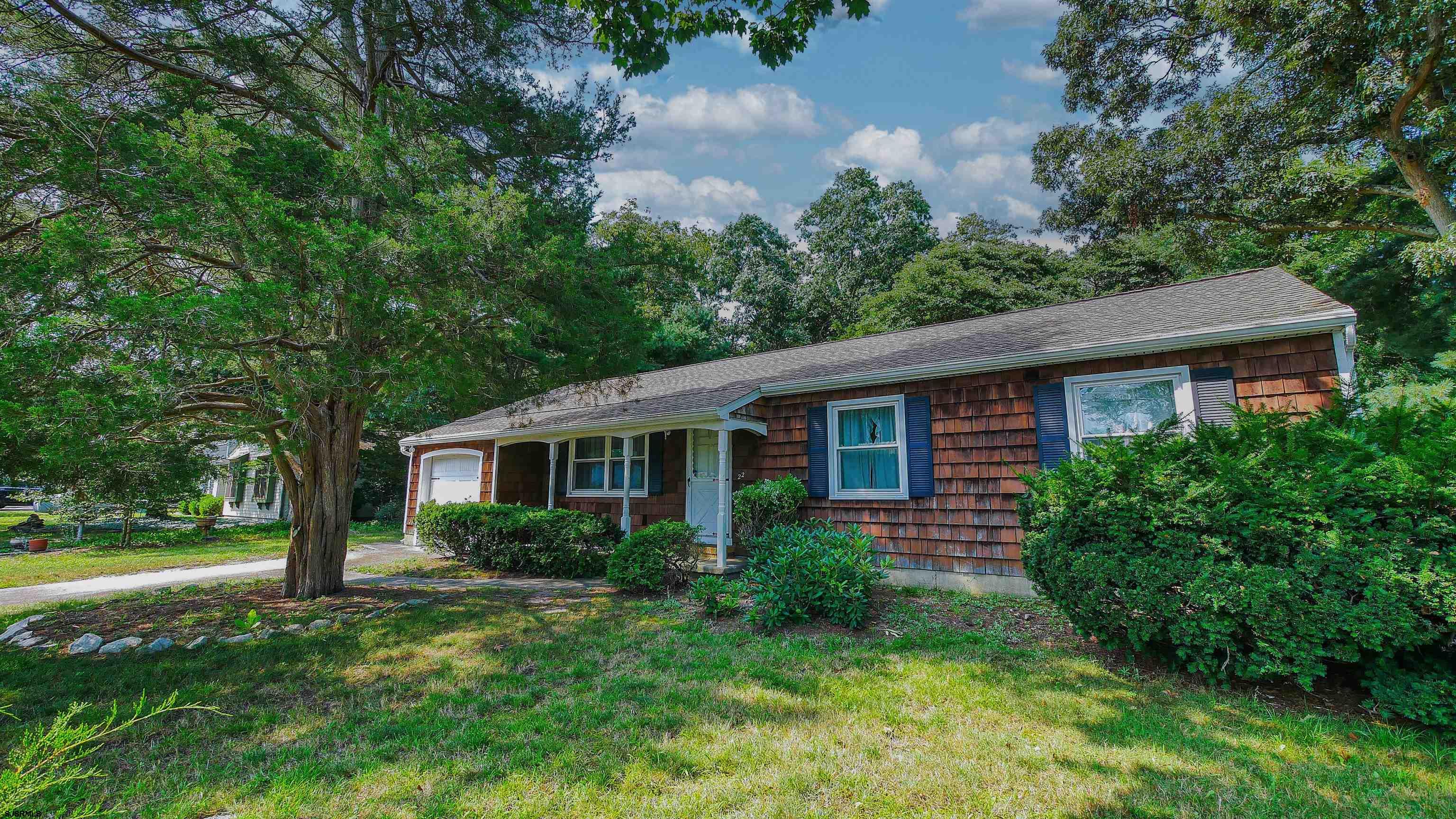 a view of house with a yard