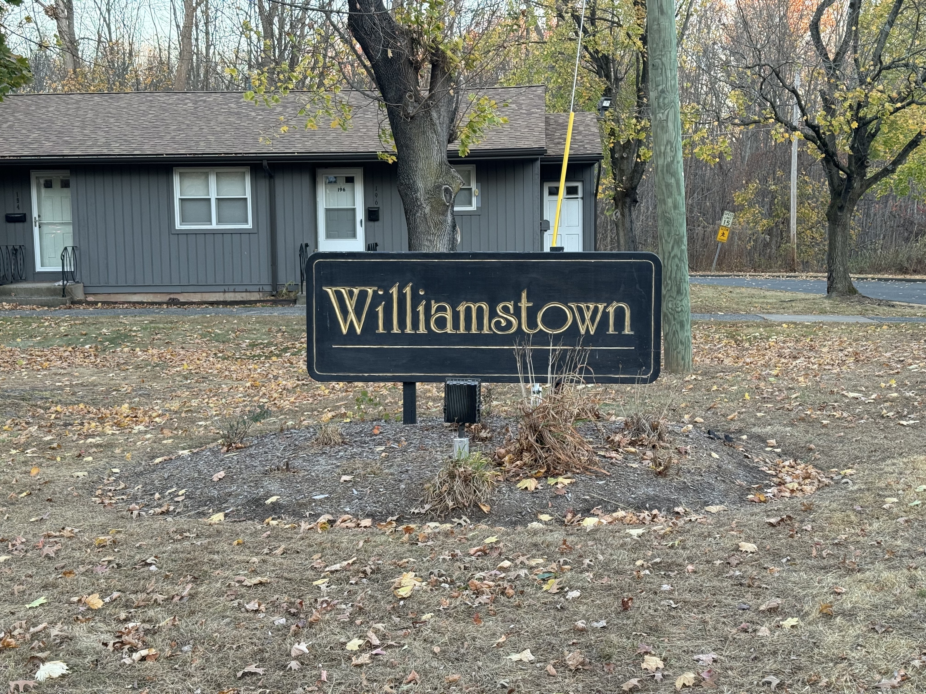 a street sign that is sitting on a brick wall