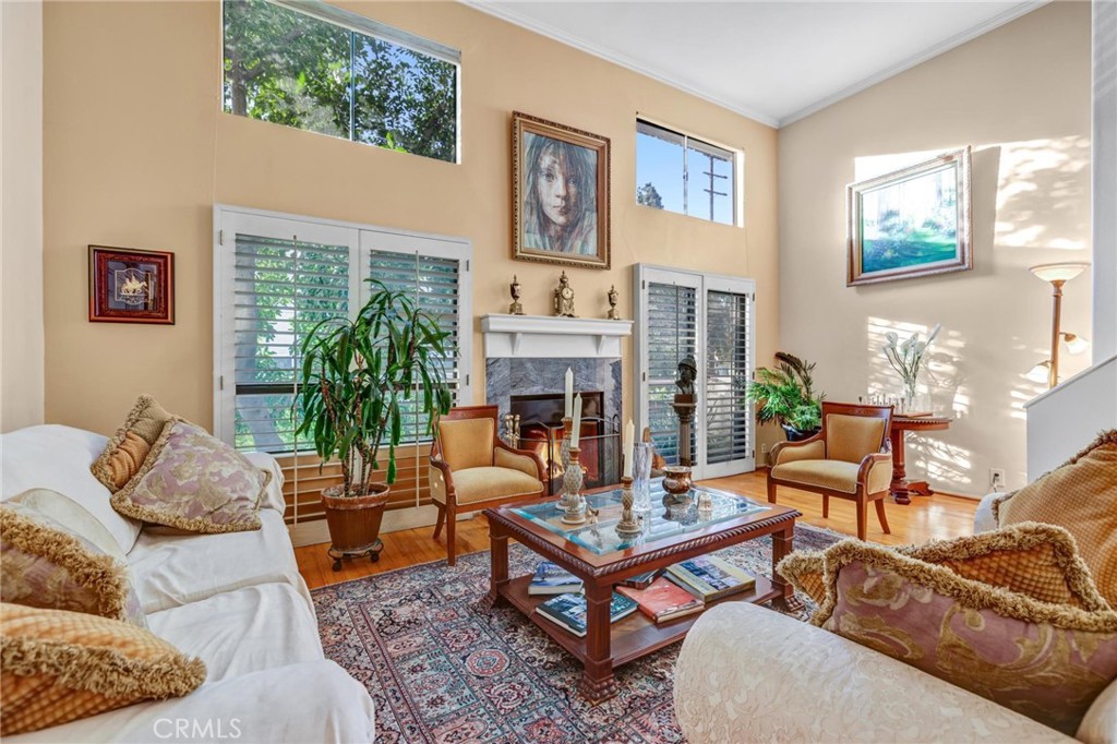 a living room with furniture fireplace and a window