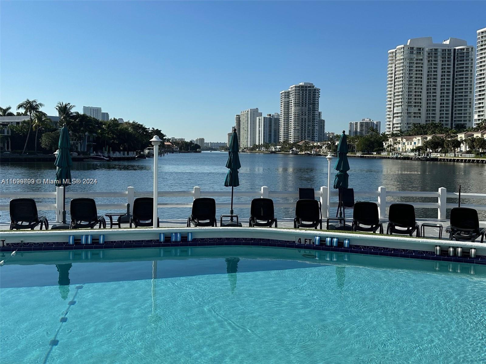 a swimming pool with outdoor seating and yard