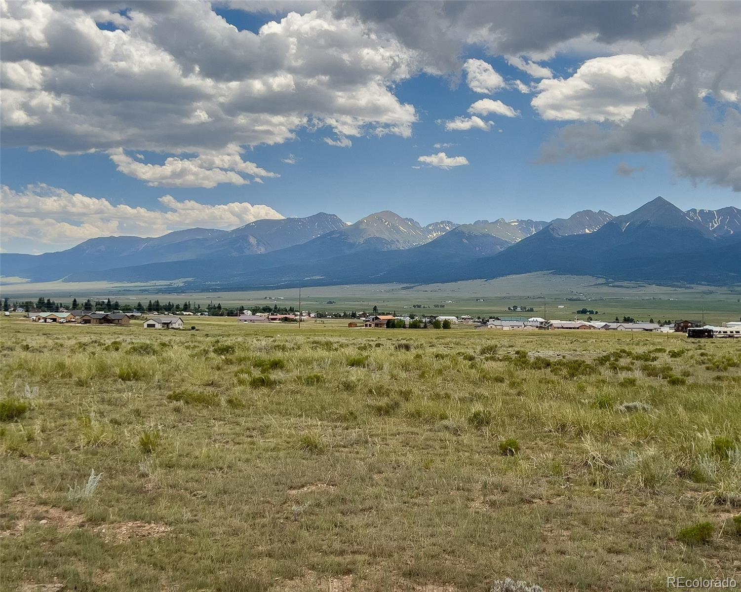 a view of a large mountain with mountains in the background