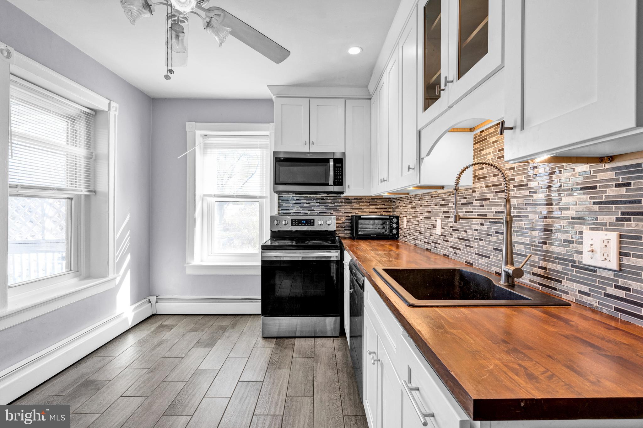 a kitchen with granite countertop a sink and a stove top oven