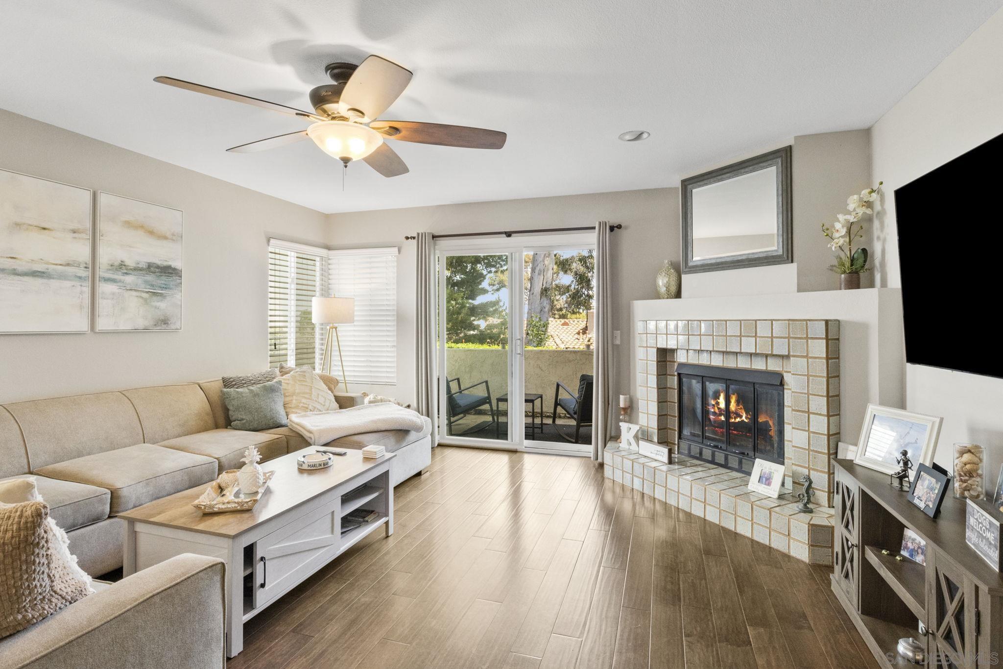 a living room with furniture fireplace and flat screen tv