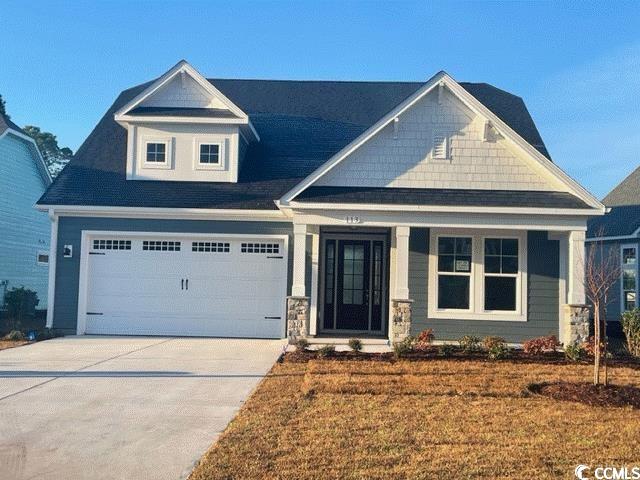 Craftsman house featuring a garage