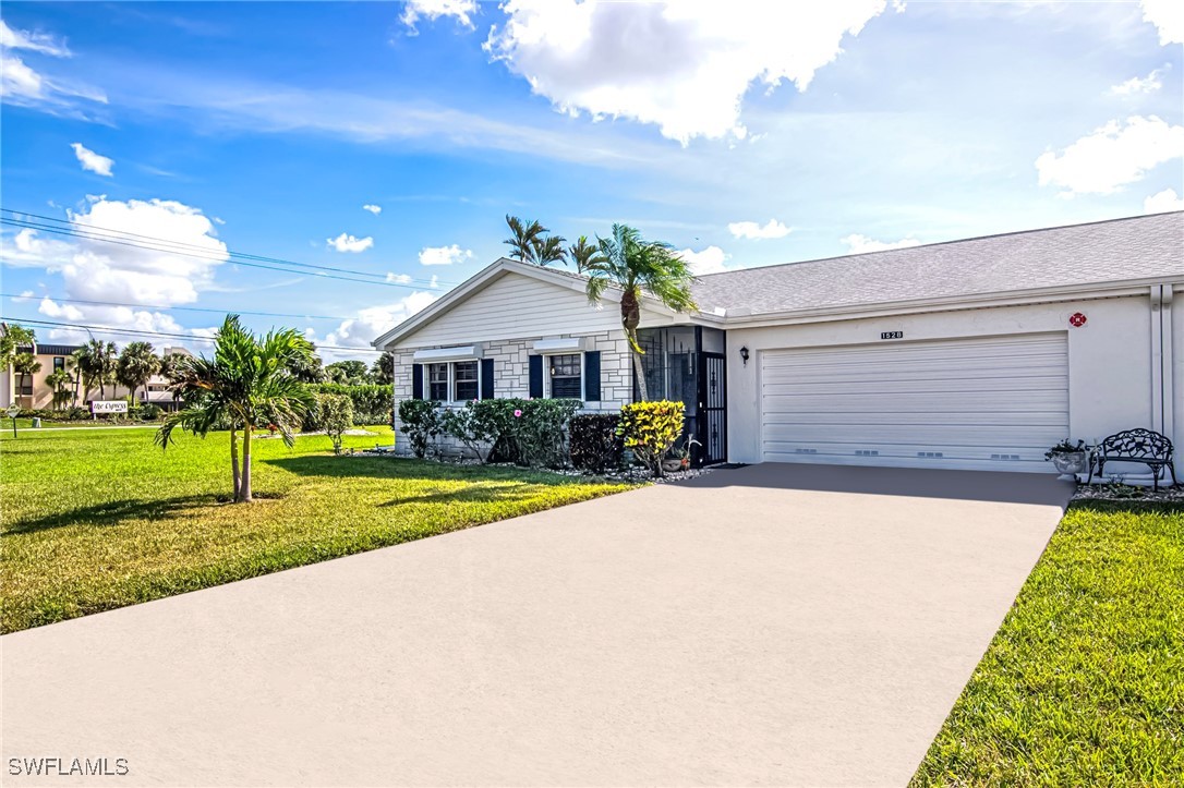 a front view of a house with a yard and garage