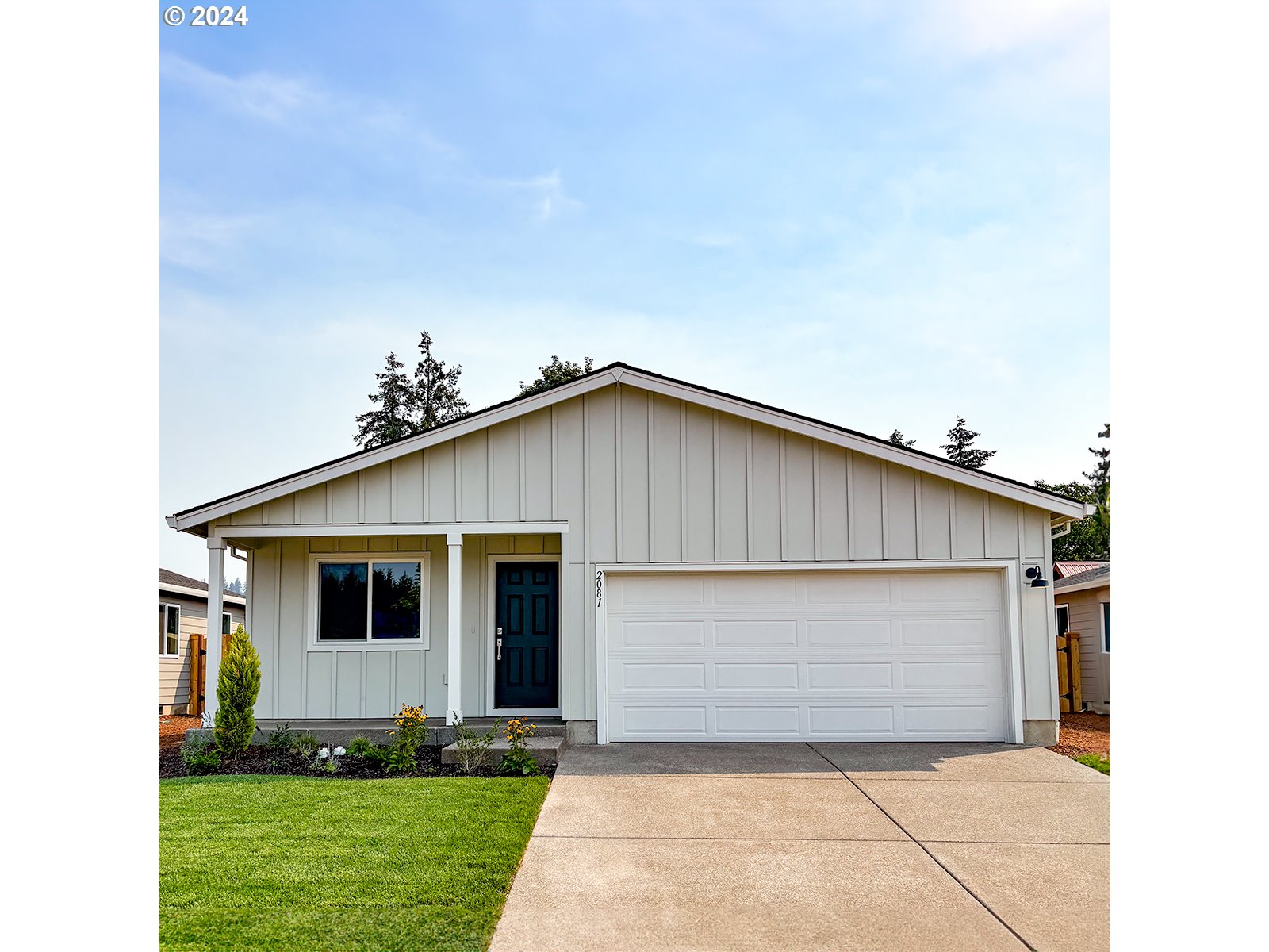 a front view of a house with a garden