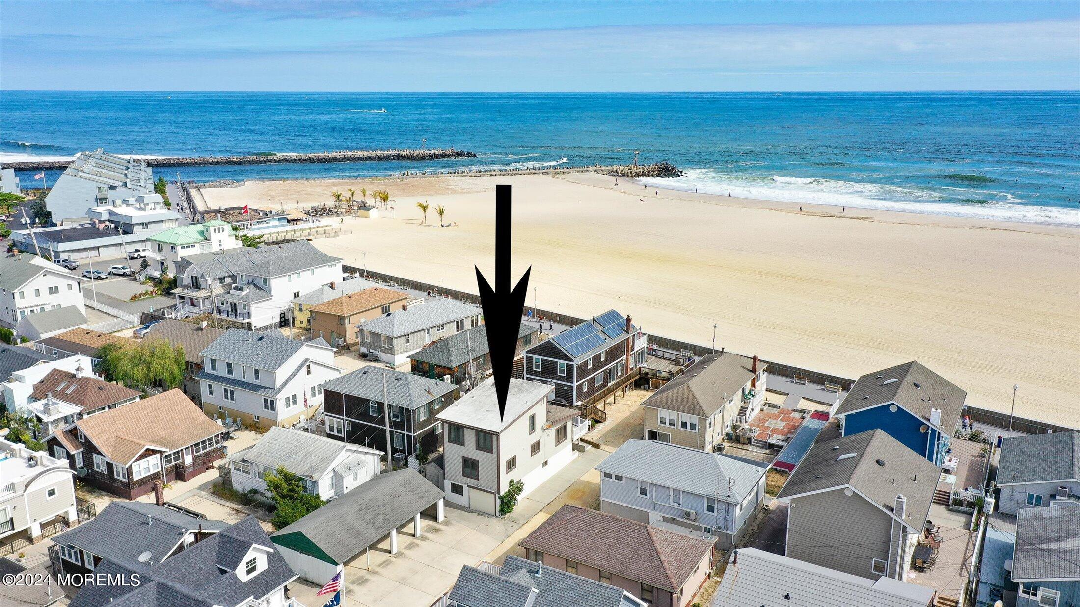 an aerial view of residential building and ocean view