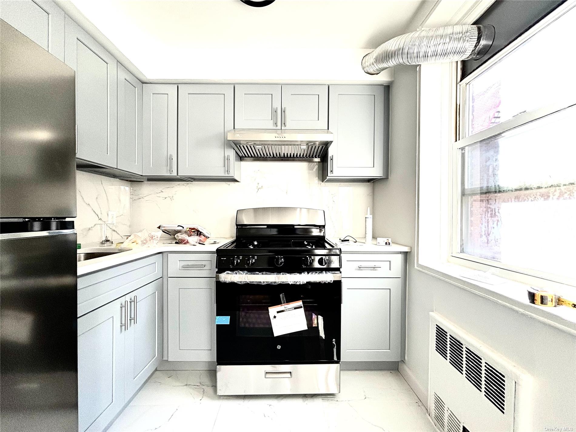 a kitchen with a stove top oven sink and cabinets