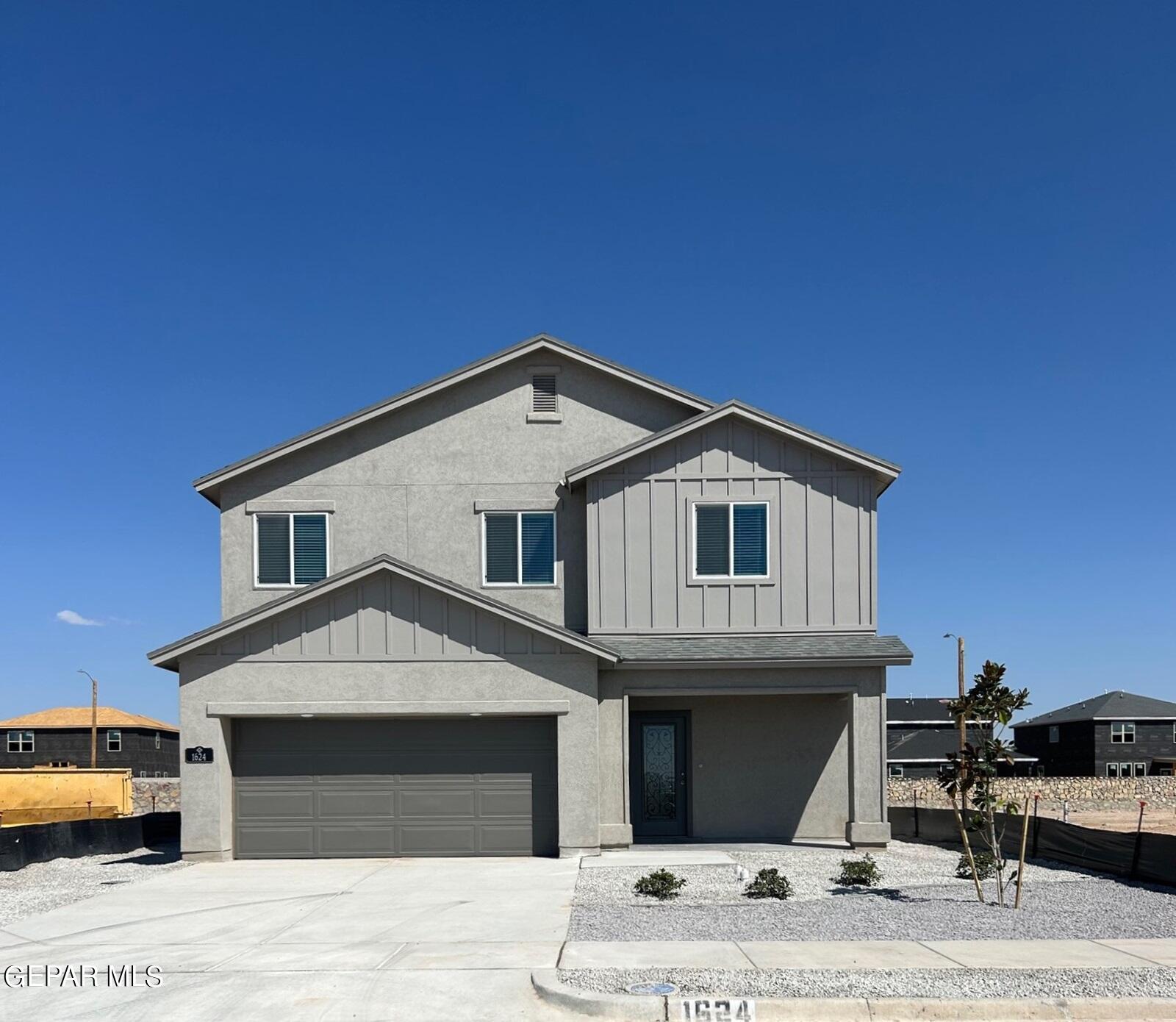 a front view of a house with garage