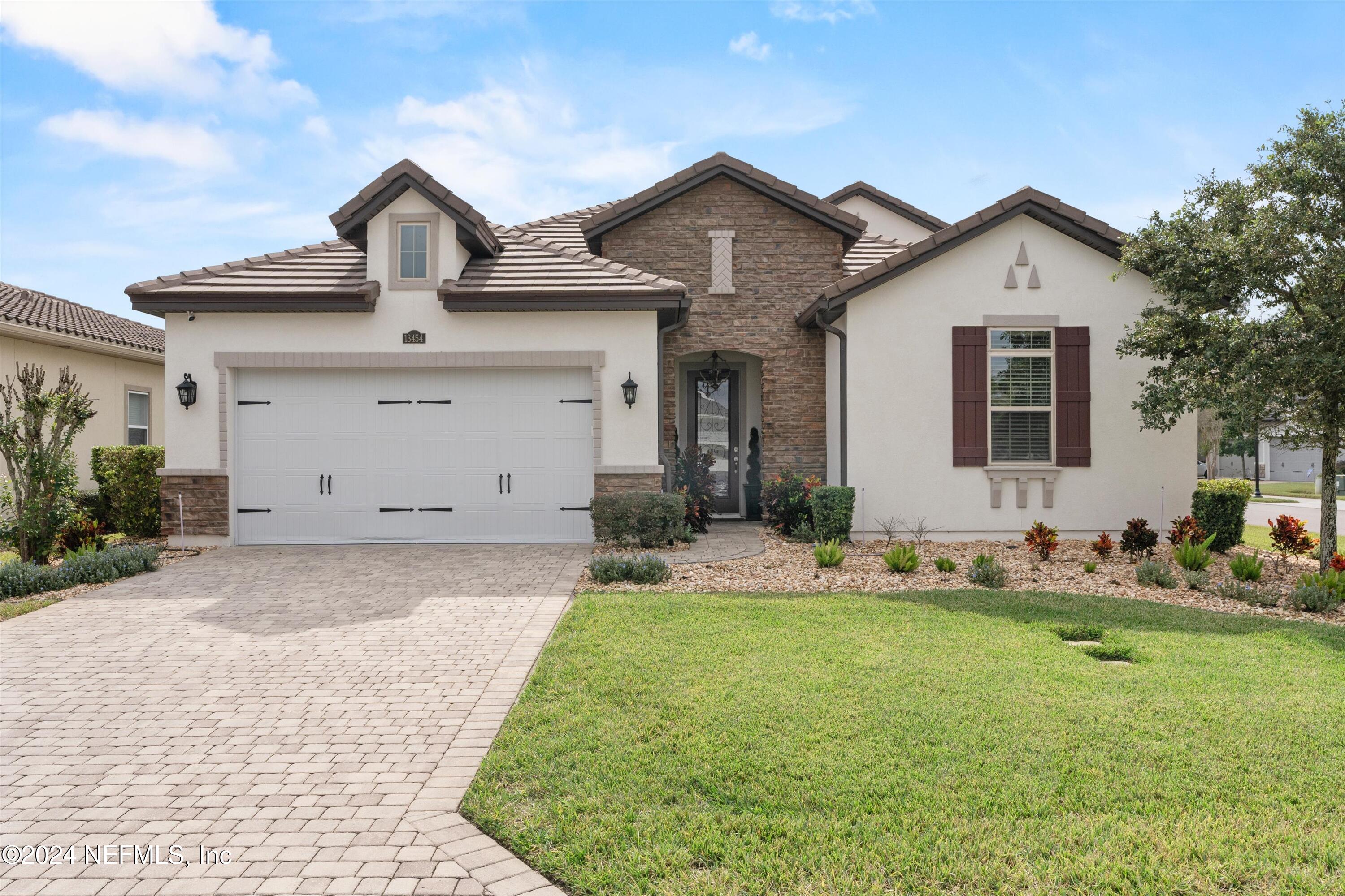 a front view of a house with garden