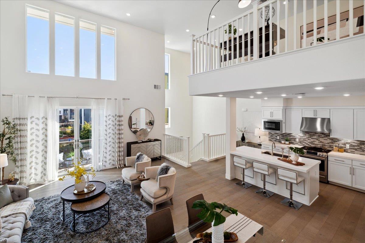 a living room with furniture kitchen and a window