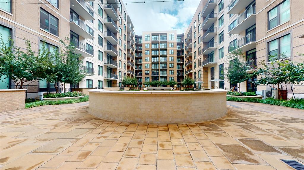 a view of building with yard and sitting area