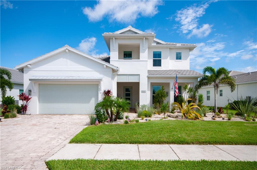 a front view of a house with a yard and garage